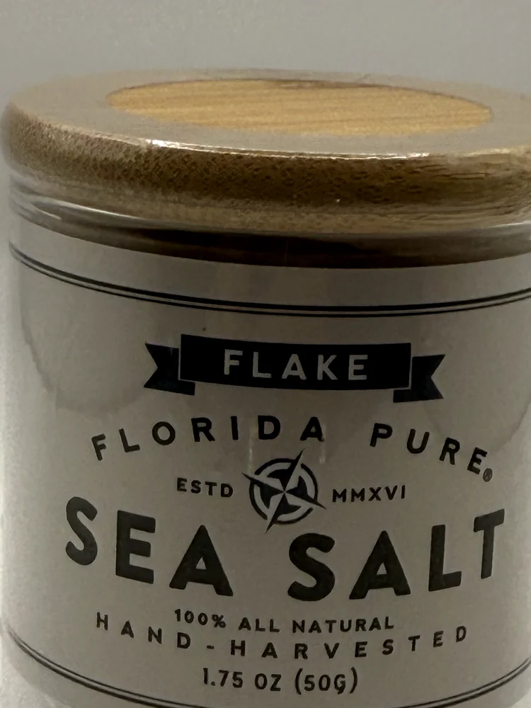 Glass jar of Florida Pure Flake Sea Salt with a white label and bamboo lid