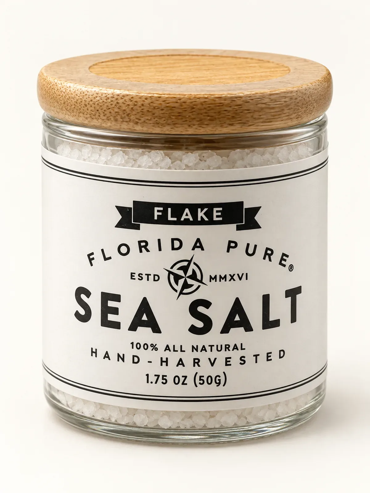 Glass jar of Florida Pure Flake Sea Salt with a white label and bamboo lid