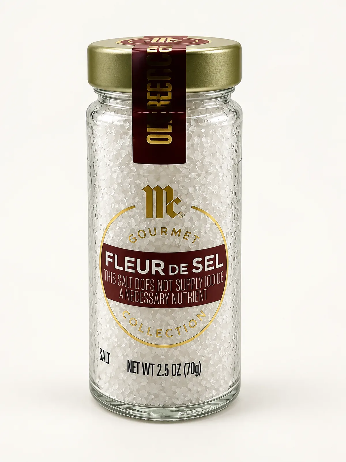 Glass jar of McCormick Gourmet Fleur de Sel with a gold lid and burgundy label