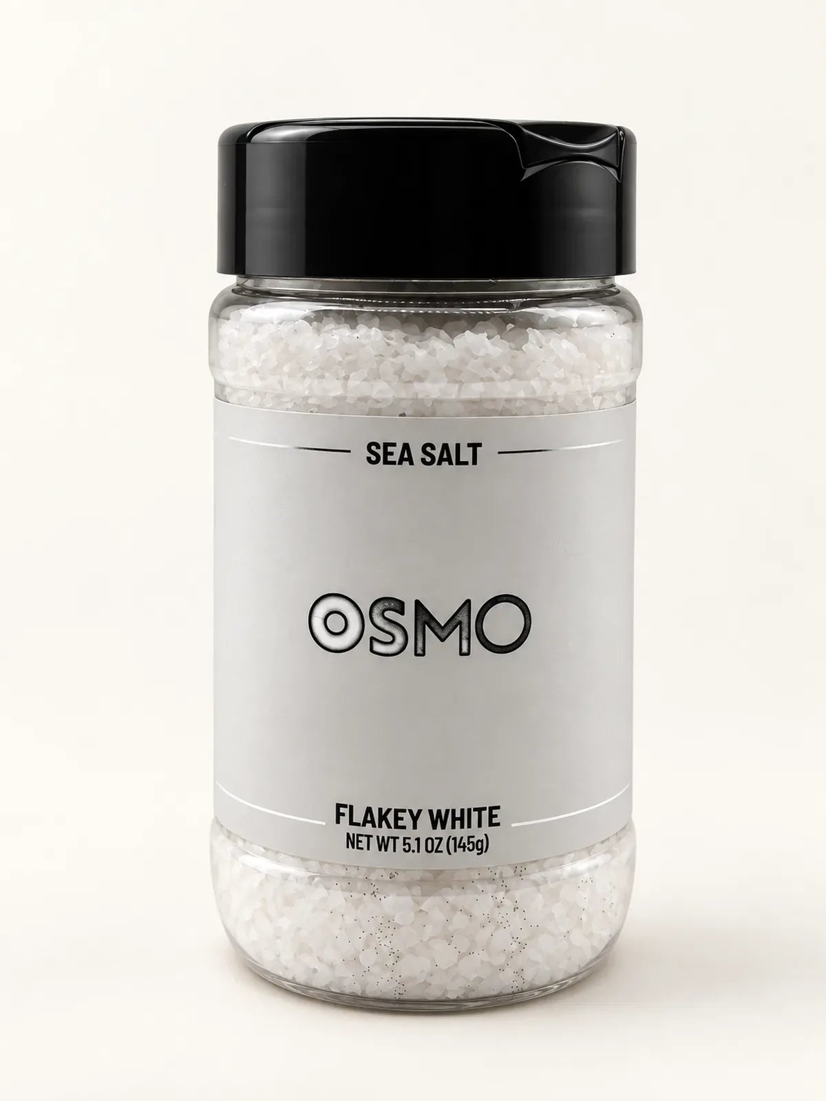 Clear plastic jar of OSMO Flakey White Sea Salt with a grey label and black lid