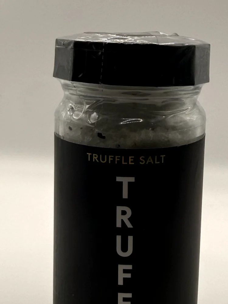 Glass jar of TRUFF Black Truffle Salt with a black label and black lid