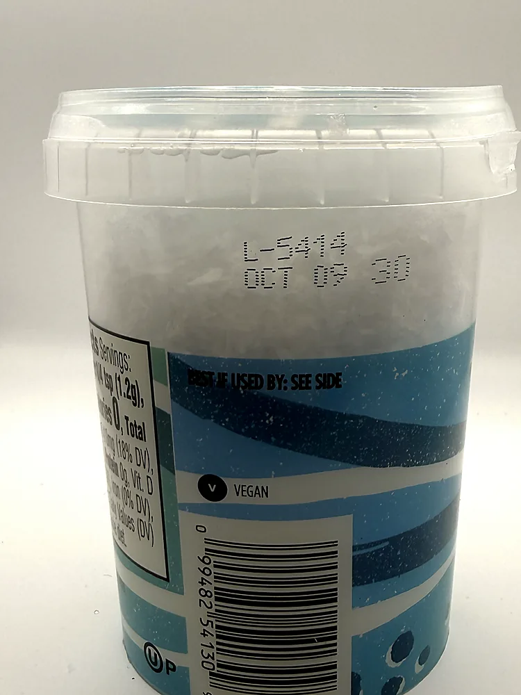 Lot, best-by date, vegan mark and barcode on Whole Foods Sea Salt Flakes